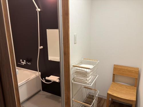 a small bathroom with a shower and a sink at Hotel art rock in Takamatsu