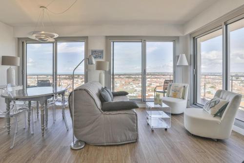 un salon avec un canapé et une table dans l'établissement Fregates - Vue mer exceptionelle au 12eme etage, à La Chaume