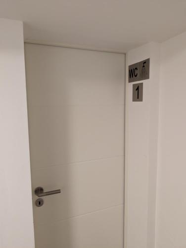 a white door with a sign on it at HarmoNest 1 Mgladbach South in Mönchengladbach