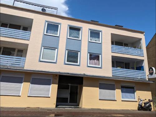an apartment building with windows and a scooter parked in front at HarmoNest 1 Mgladbach South in Mönchengladbach