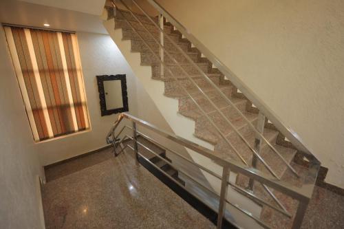 a staircase with a metal railing in a building at Royal Taj Twin Palace near Taj Mahal in Agra