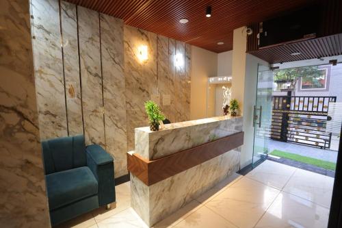 a lobby with a reception counter and a chair at Royal Taj Twin Palace near Taj Mahal in Agra