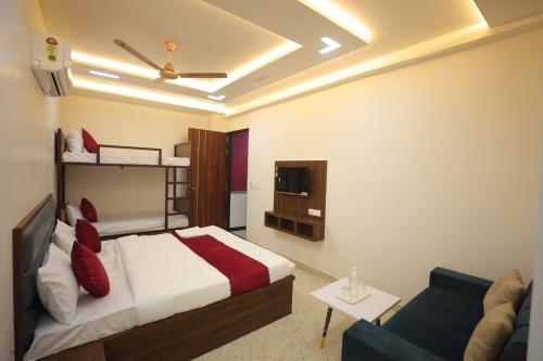 a bedroom with a bed and a couch at Royal Taj Twin Palace near Taj Mahal in Agra