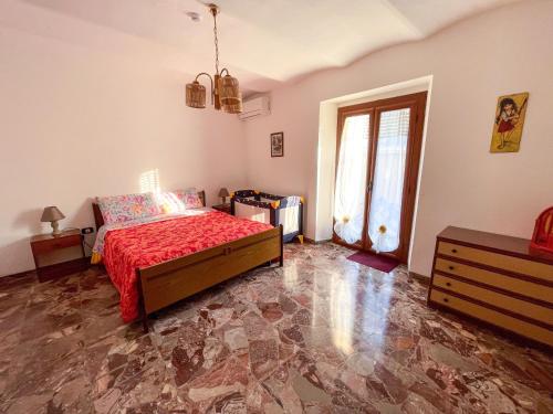 a bedroom with a bed and a dresser and a window at Flowers & Angels Home in Santa Maria degli Angeli