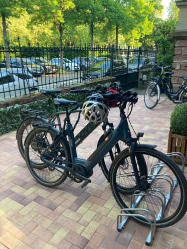 a bike is parked on a brick sidewalk at Le Relais de l'Orangerie in Strasbourg