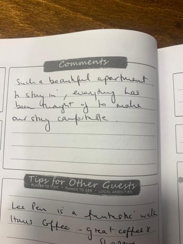 a notebook with handwriting on it on a table at Stravaig in Innerleithen