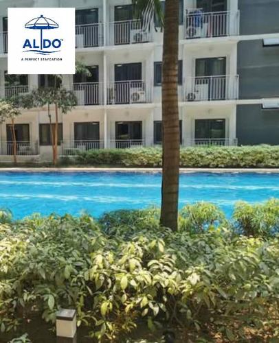 a swimming pool in front of a building at Mall of Asia condotel shore 3 residence in Manila
