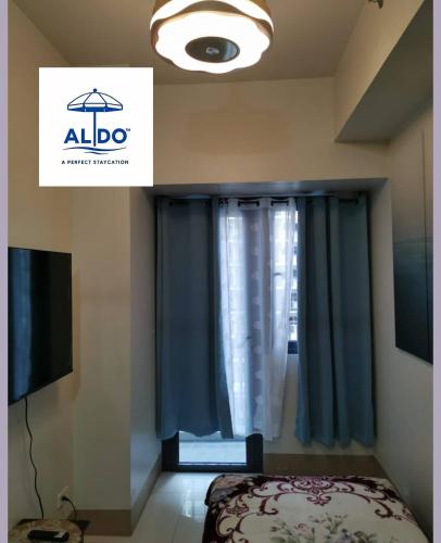 a bedroom with a bed and a window at Mall of Asia condotel shore 3 residence in Manila