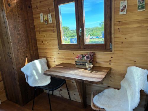 a wooden room with a table and two chairs at Gypsy terramare in Valledoria