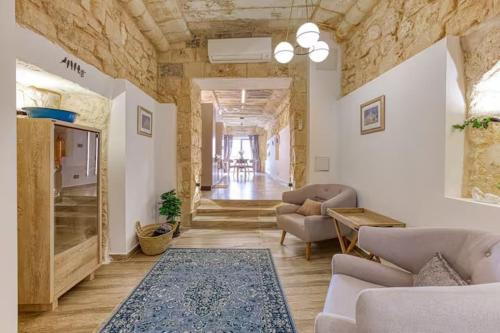 a living room with a couch and a table at Family Home with Jacuzzi, 3BR Countryside in Dingli in Dingli