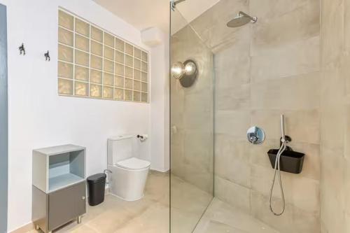 a bathroom with a glass shower with a toilet at Family Home with Jacuzzi, 3BR Countryside in Dingli in Dingli
