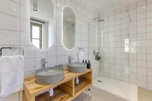 a bathroom with two sinks and a mirror at Family Home with Jacuzzi, 3BR Countryside in Dingli in Dingli