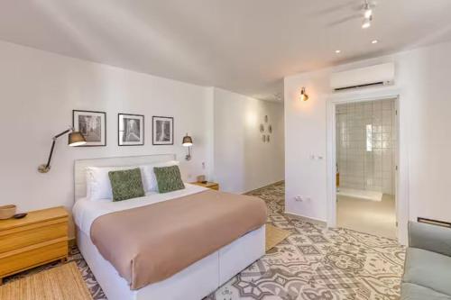 a bedroom with a large bed and a couch at Family Home with Jacuzzi, 3BR Countryside in Dingli in Dingli