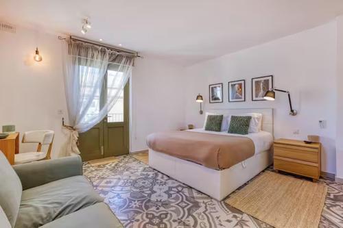 a bedroom with a large bed and a couch at Family Home with Jacuzzi, 3BR Countryside in Dingli in Dingli