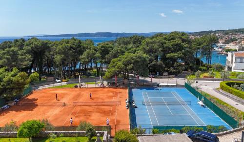 an overhead view of a tennis court with people on it at Seaside apartments Petar in Krk