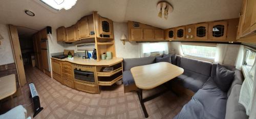 an interior of an rv with a table and a kitchen at Trysil Caravan Cycle in-out in Trysil
