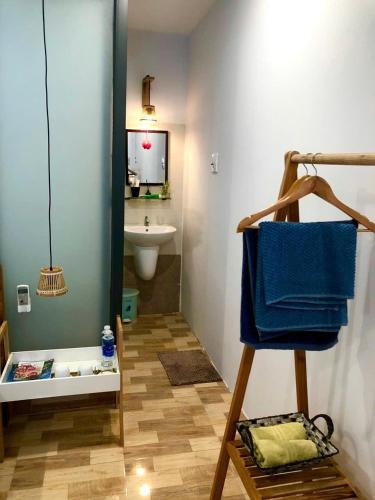 a bathroom with a sink and a blue towel at Duy Tan Home in Quy Nhon