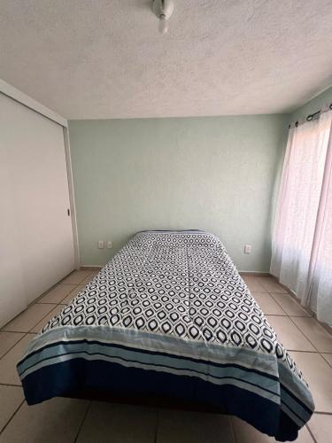a bedroom with a bed in the corner of a room at Smart Home en Tlajomulco de Zúñiga in Santa Cruz de las Flores