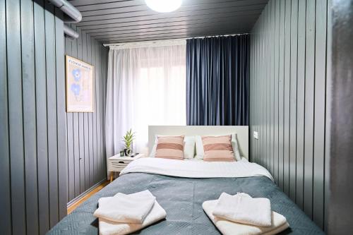 a bedroom with a large bed with two pillows at Studio Near Airport WiFi Valea Crucii 6 in Chişinău