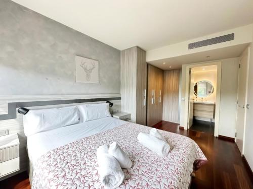 a bedroom with a large bed with two towels on it at Barcelona Forum Pool and Parking included and Beach 5min in Sant Adria de Besos