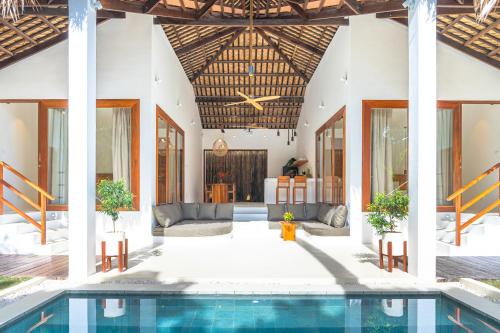 a villa with a swimming pool and a house at SEACLUB Siargao in General Luna
