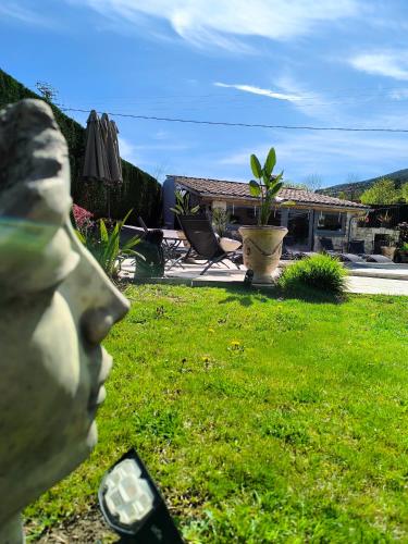 a statue of a head in a yard at La babounette in Jaujac