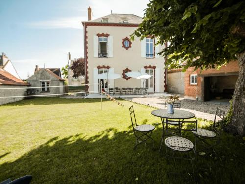 a table and chairs in front of a house at Maison Baron - Bourgeois Residence 1h30 from Paris in Boiscommun