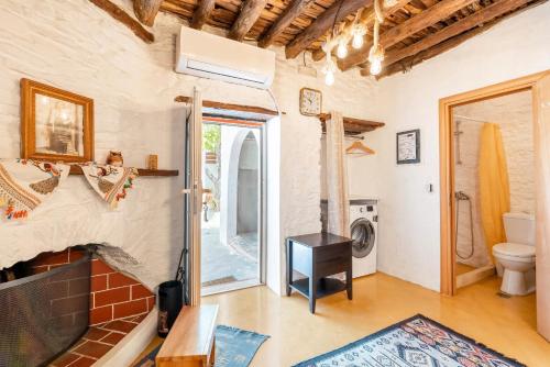 a living room with a fireplace and a toilet at Mannas House 2 in Émbonas