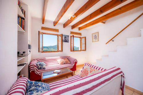 a living room with two couches and a staircase at Eliasneil in Andratx