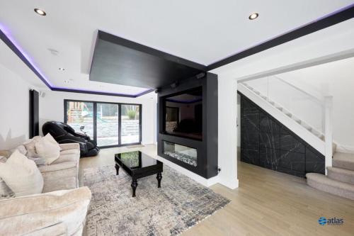 a living room with a couch and a fireplace at Large NEW Detached House Woolton, Families, FREE Parking, Massage, BBQ, Play room & MORE in Woolton