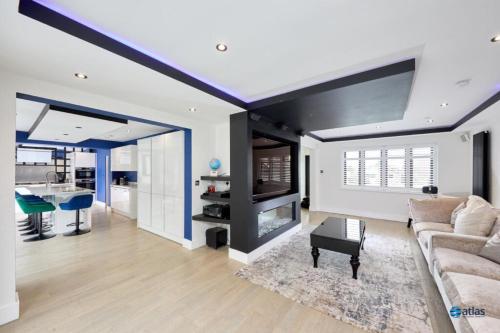 a living room with a couch and a table at Large NEW Detached House Woolton, Families, FREE Parking, Massage, BBQ, Play room & MORE in Woolton