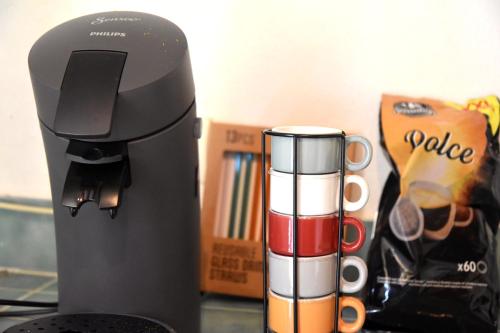 a coffee machine sitting on a counter with a cup at Paradis Provencal Le Calme total, Grande Piscine et Jacuzzi Chauffé, Salle de Jeux et Fresque du Nougat, Intimité in Montélimar