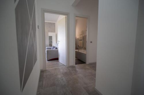 a hallway with a living room and a room with a couch at Casa Ella in Florence
