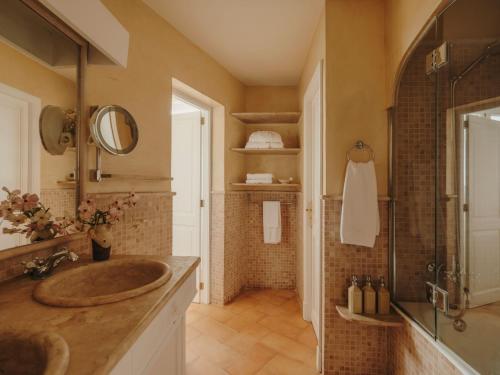 a bathroom with a sink and a shower at La Residencia, A Belmond Hotel, Mallorca in Deia