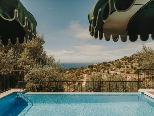 a swimming pool with a view of the ocean at La Residencia, A Belmond Hotel, Mallorca in Deia