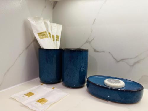 two blue vases sitting on top of a counter at The Astra Sky River Chiang Mai 三卧两卫宜居6人 无边泳池 热水浴缸 乳胶床垫 in Chiang Mai
