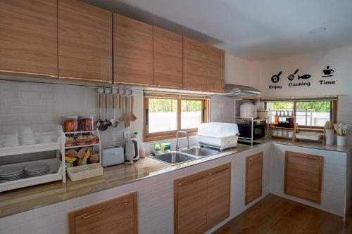 a kitchen with a sink and a counter top at Ongsa Poolvilla At Udonthani in Ban Dong Saphang