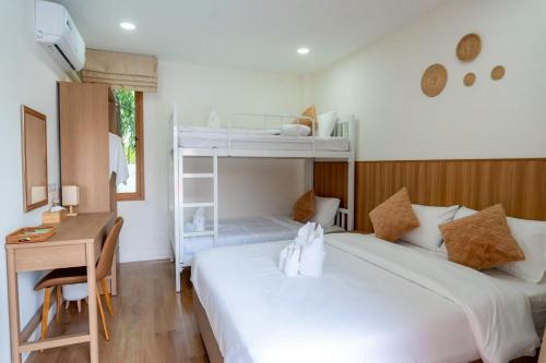 a bedroom with two bunk beds and a desk at Ongsa Poolvilla At Udonthani in Ban Dong Saphang