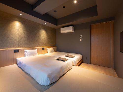 Una cama o camas en una habitación de Onn Oomagarinohanabi
