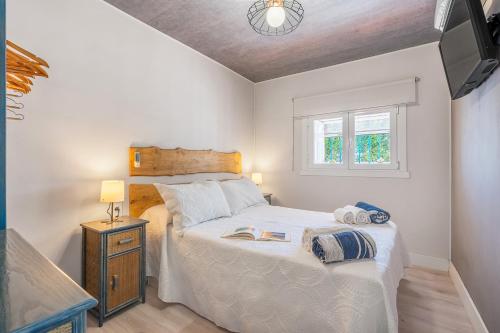 a bedroom with a bed and a television in it at Villa Buganvilla en Salobreña in Salobreña