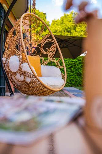 a wicker swing sitting on a table at Modena Garden Retreat, 5 min dal centro con Garage in Modena
