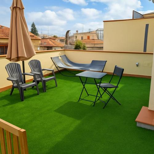 a patio with chairs and a table and a slide at Appartamenti Penelope in Mondello