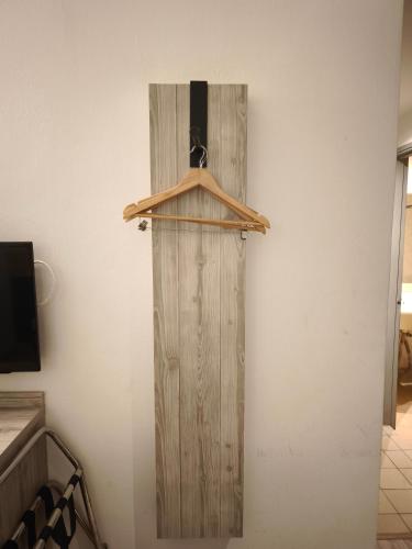 a wooden door on a wall in a room at Alamis City Kuala Lumpur - Formerly EDC Hotel Kuala Lumpur in Kuala Lumpur