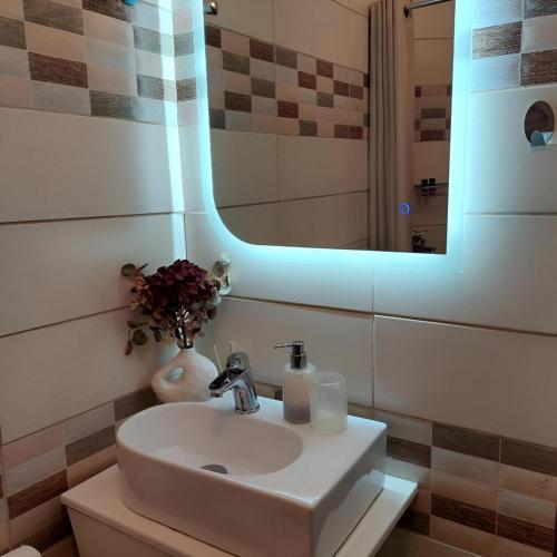 a bathroom with a sink and a mirror at La Dolce Vita in Chalkida