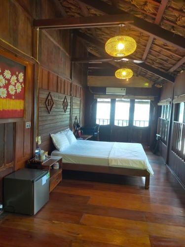 a bedroom with a large bed in a room at Cham Island Wooden Cabin in Hoi An