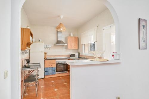 a kitchen with a white refrigerator and a counter at Villa La Macera in Frigiliana