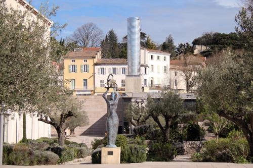 a statue of a woman in front of a building at Paradis Provencal Le Calme total, Grande Piscine et Jacuzzi Chauffé, Salle de Jeux et Fresque du Nougat, Intimité in Montélimar