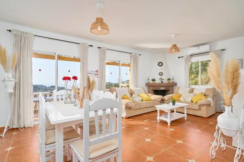 a living room with a couch and a table at Villa La Macera in Frigiliana