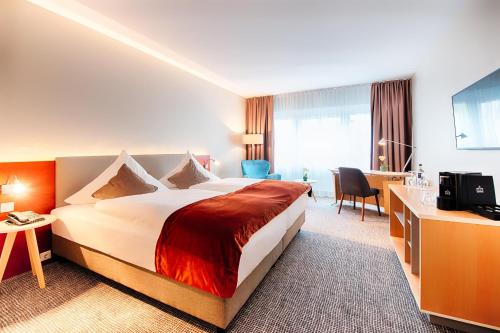 Postel nebo postele na pokoji v ubytování Welcome Hotel Marburg