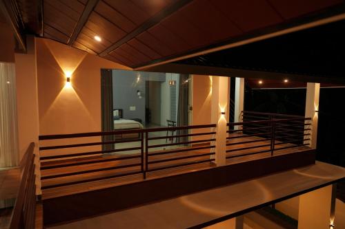 a view of the balcony of a house at night at The Calm County Homestay in Mānantoddy